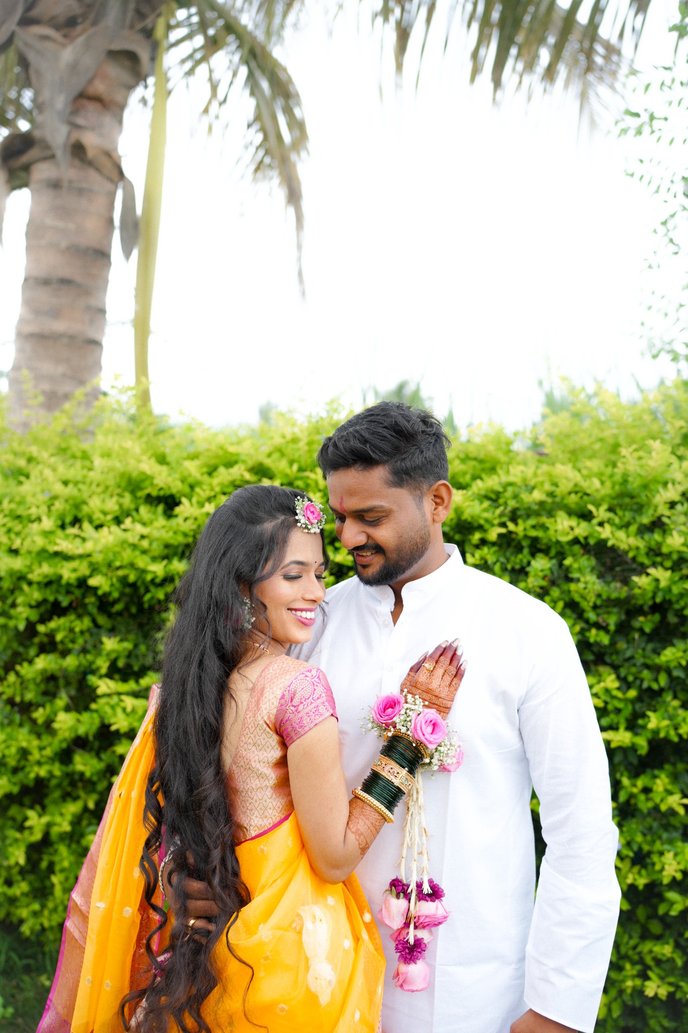 Newly married couple beneath the palms